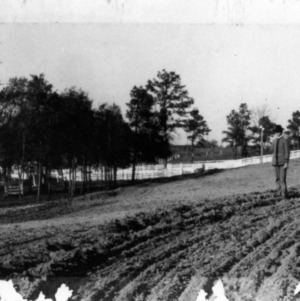 Professor Frank E. Emery and student examining agriculture work on campus