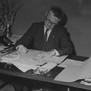 Gerald O. T. Erdahl at desk