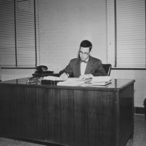 Ralph E. Fadum at desk