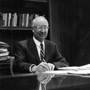 H. Brooks James at desk