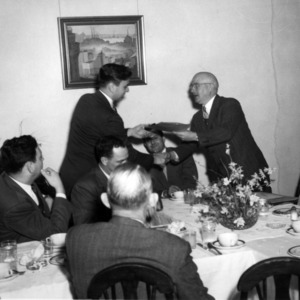 J. Harold Lampe giving award at dinner