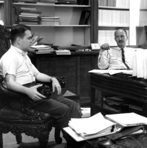 Dr. Raymond L. Murray in office with student