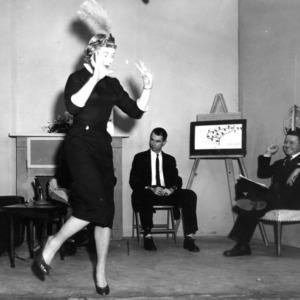 Rudolph Pate and other watching woman dance at event