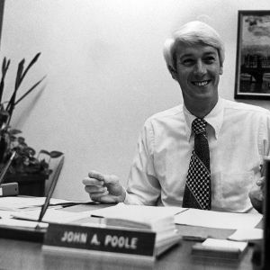 Dean John Poole at desk