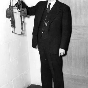 Professor G. H. Satterfield holding bridle to discourage students from "peeping" during exams