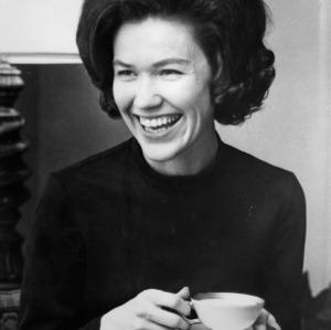 Mrs. Patricia Holshouser smiling and holding coffee