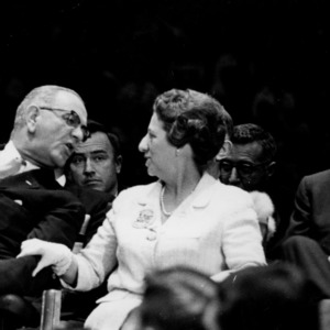 Lyndon B. Johnson leans to talk to Mrs. Jeanne Moore