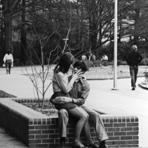 Two students kissing on campus