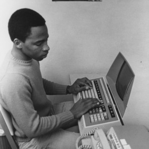 Student Willard C. Cooper at computer