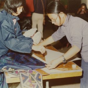 Two students at booth at international fair