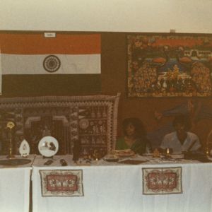 Two people at India booth at international fair