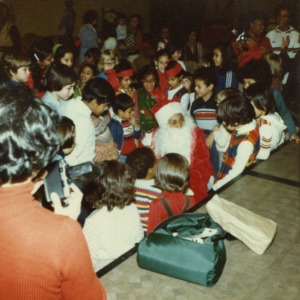 Children and man in Santa suit at international fair