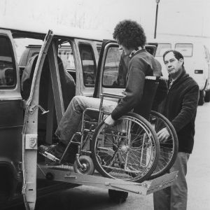 Student on lift for wheelchair accessible van