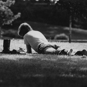 Student studying on grass