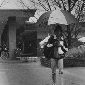 Student with umbrella in snow