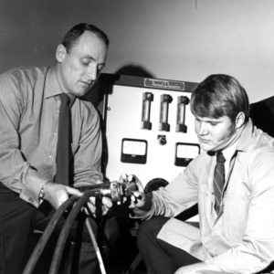 Two men with scientific equipment