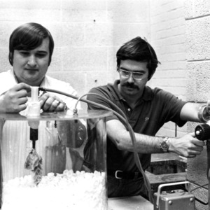 Two students conducting an experiment