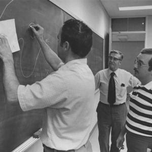 Men at classroom blackboard