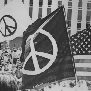Peace sign flags and American flag at peace demonstration