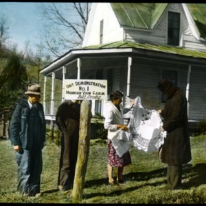 Four people in front of demonstration house