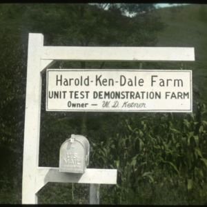 Mailbox with a sign attached that reads, "Harold Ken Dale Farm - Unit Test Demonstration Farm - owner W. D. Ketner"
