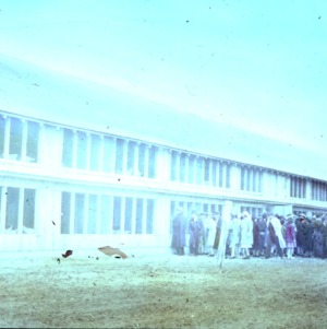 Large group of people in front of chicken house