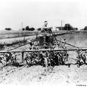 Farm implement attached to tractor