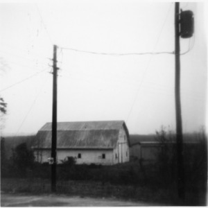 Farm building and electricity pole