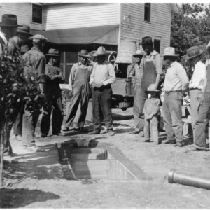 Farmers listning to lecture on septic tank by W. G. Ward,  Extension Architect, Kansas State Agricultural College.  Jacob Hoffman Farm