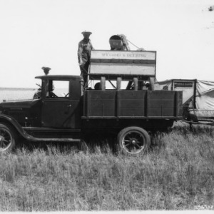 Truck and McCormick Deering Grain Harvesting Machine