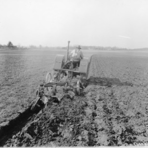 Tractor and Cultivator in Field