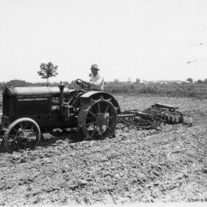 McCormick-Deering Tractor with Disc in Field