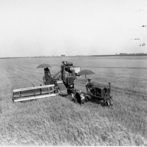 Farmall Tractor operating a McCormick-Deering  Combine