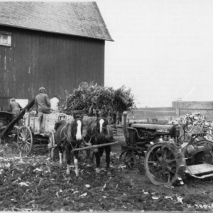 McCormick-Deering Corn Husker and Shredder blowing shredded corn stover into barn