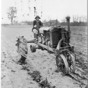 Woman on tractor in field