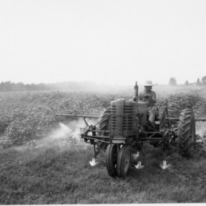 Man on tractor spraying crops