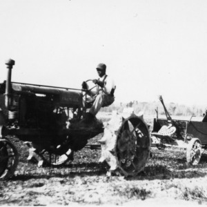 Man operating manure spreader
