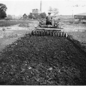 Man operating tractor and Roderick Lean automatic tractor discs