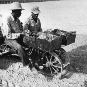 Men operating Ford agricultural machinery