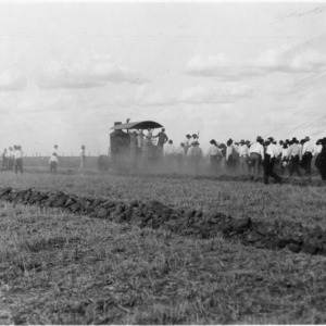 Men in field with agricultural machinery