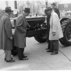 Men examining tractor