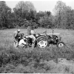 Men preparing tractor for planting sod