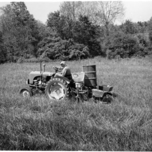 Man on tractor planting sod
