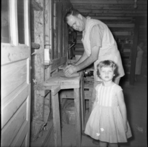 Potter Ben Owen Sr. at pottery wheel with young girl