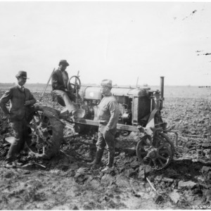 Men with tractor in field