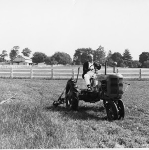 Man operating tractor and agricultural machinery