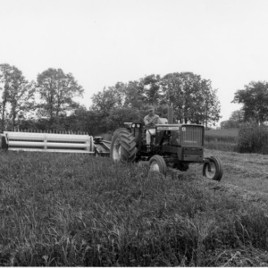 Man operating tractor and agricultural machinery