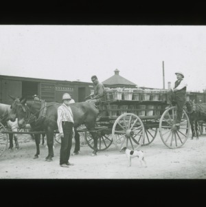 Loading fruit baskets onto train cars, circa 1910