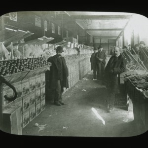 Men at New York Fruit Exchange stalls, circa 1900