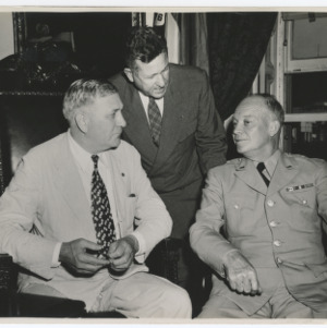 Eisenhower seated with others